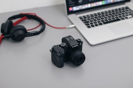 DSLR Camera, MacBook and Headphones Free Stock Photo
