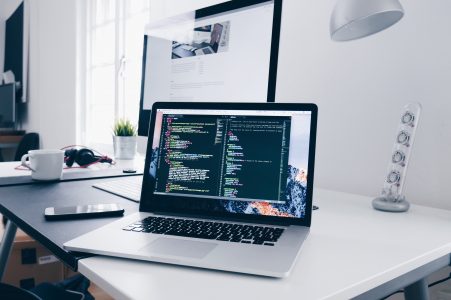Code on a MacBook Laptop in Minimal Office Free Stock Photo