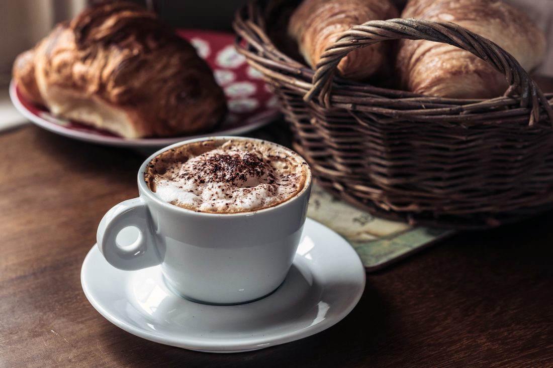 Free photo of Frothy Coffee & Croissant