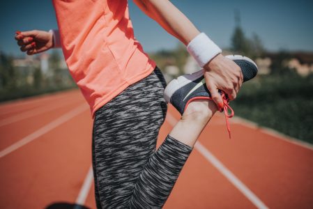 Woman Stretching On Track Field Free Stock Photo
