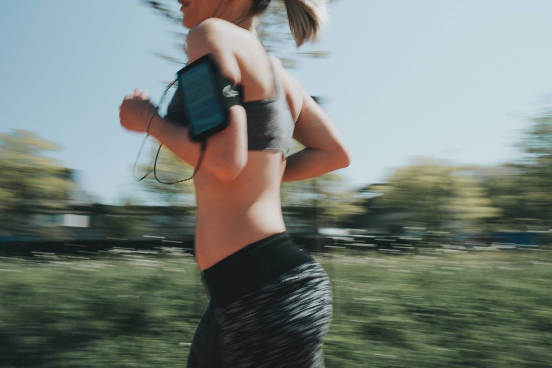 Free photo of Woman Running with Mobile Phone