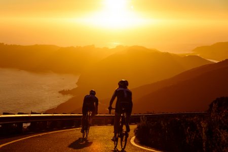 Men Cycling at Sunset Free Stock Photo