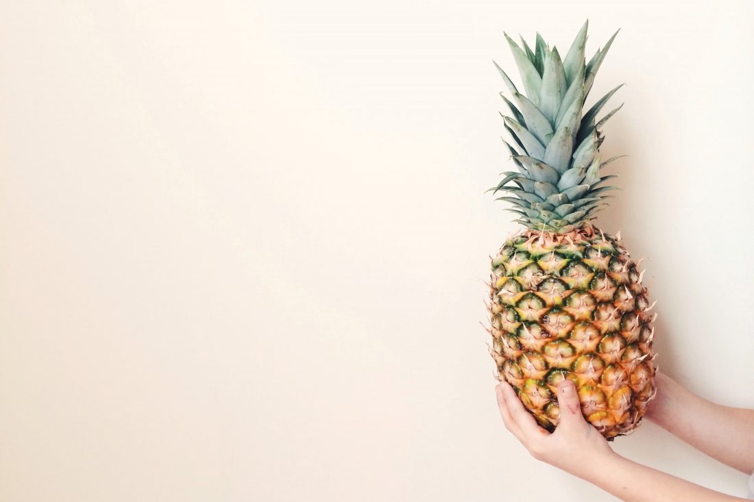 Free photo of Holding Pineapple