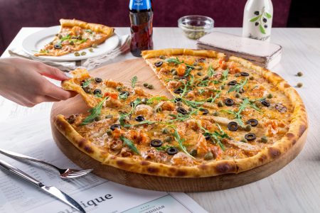 Hand Grabbling Pizza Slice Free Stock Photo