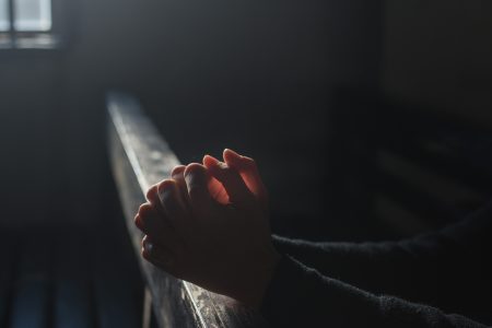 Hands Praying in Church Free Stock Photo