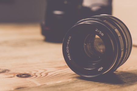 Camera Lens on Wooden Table Free Stock Photo