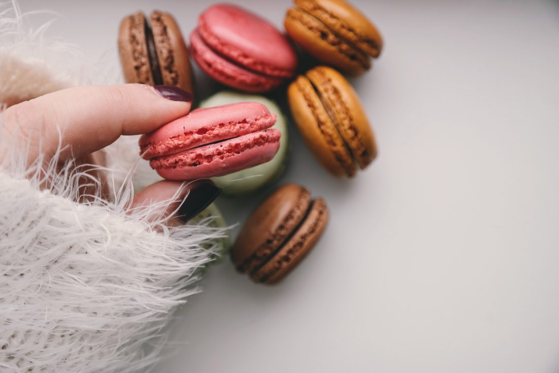 Free photo of Woman Holding Macarons