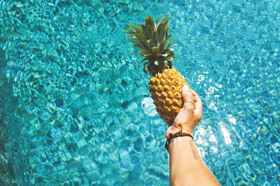 Free photo of Man Holding Pineapple
