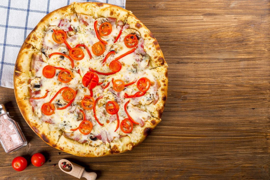 Free photo of Pizza on Wood Table