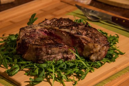 Juicy Rib Steak on Wooden Table Free Stock Photo
