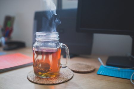 Hot Tea Jar & Computer Desk Free Stock Photo