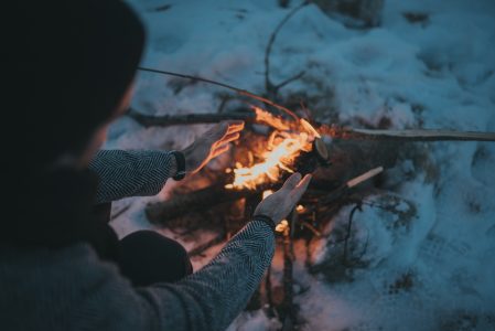 Woman Warming at Camp Fire Free Stock Photo