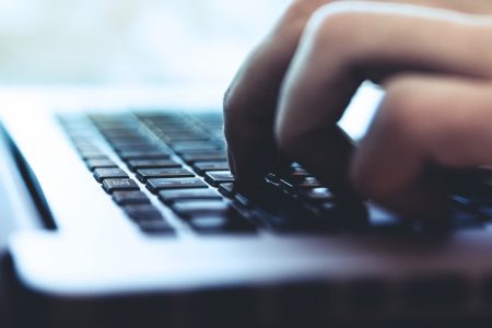 Person Typing on Keyboard Free Stock Photo