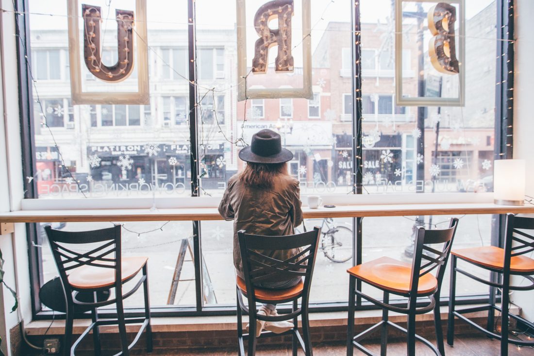Free photo of Woman Sitting at Window Coffee Shop