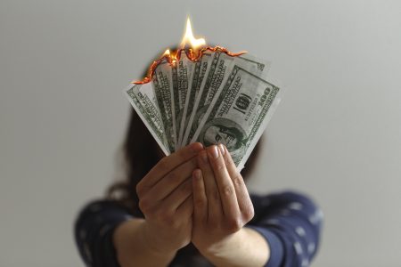 Hand Holding Bills on Fire Free Stock Photo