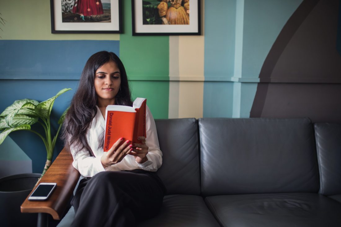 Free photo of Woman Reading on Couch